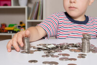 child-glasses-young-businessman-plays-with-coins child-glasses-young-businessman-plays-with-coins